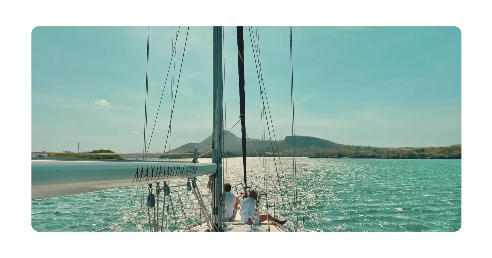 Green sailboat Galaxie on turquoise water in Spanish Waters Curacao