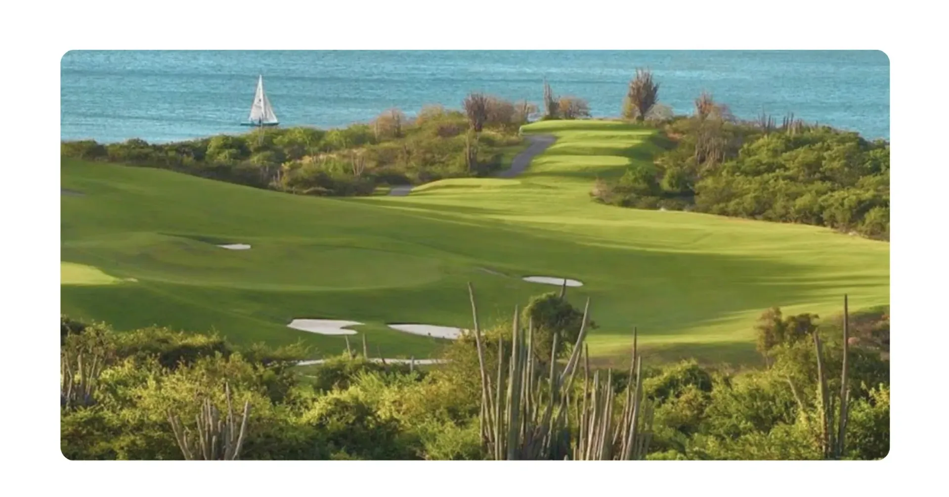 Old Quarry Course overlooking Caribbean Sea with sailboat