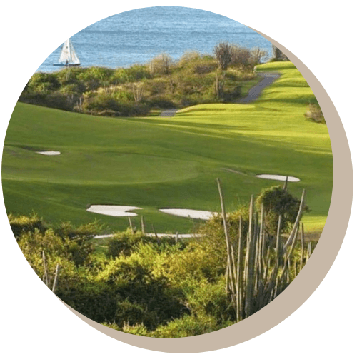 Old Quarry Coarse with green grass, sand traps, and ocean view