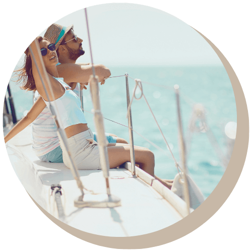 Couple on a yacht, enjoying the ocean view, sunny day.