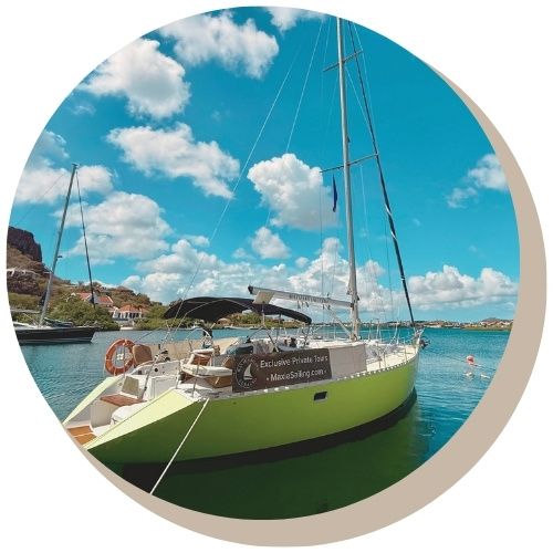 Lime-green sailboat Galaxie docked at sunset with harbour view