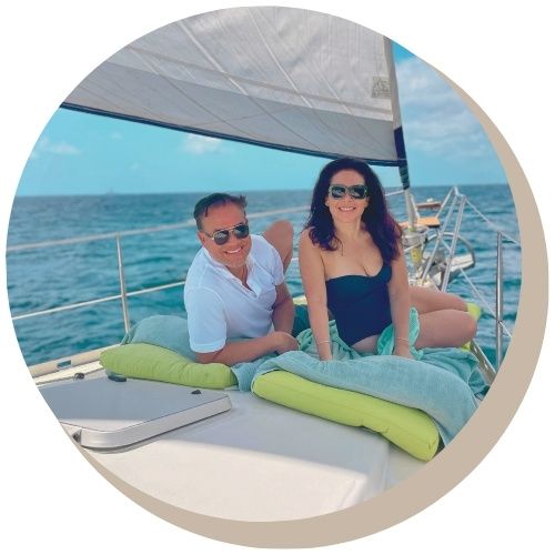 Couple on sailboat Galaxie enjoying one of the private Maxie Sailing Sandals Curacao Excursions at sunset