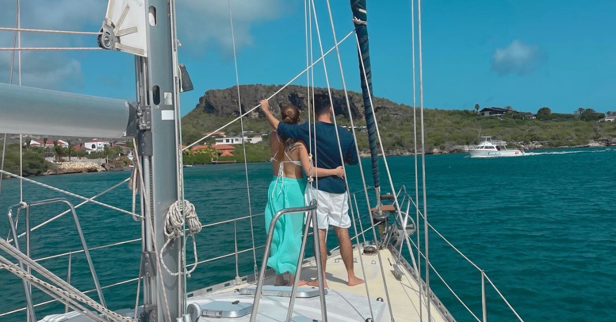 Green sailboat Galaxie on turquoise water in Fuik Bay Curacao