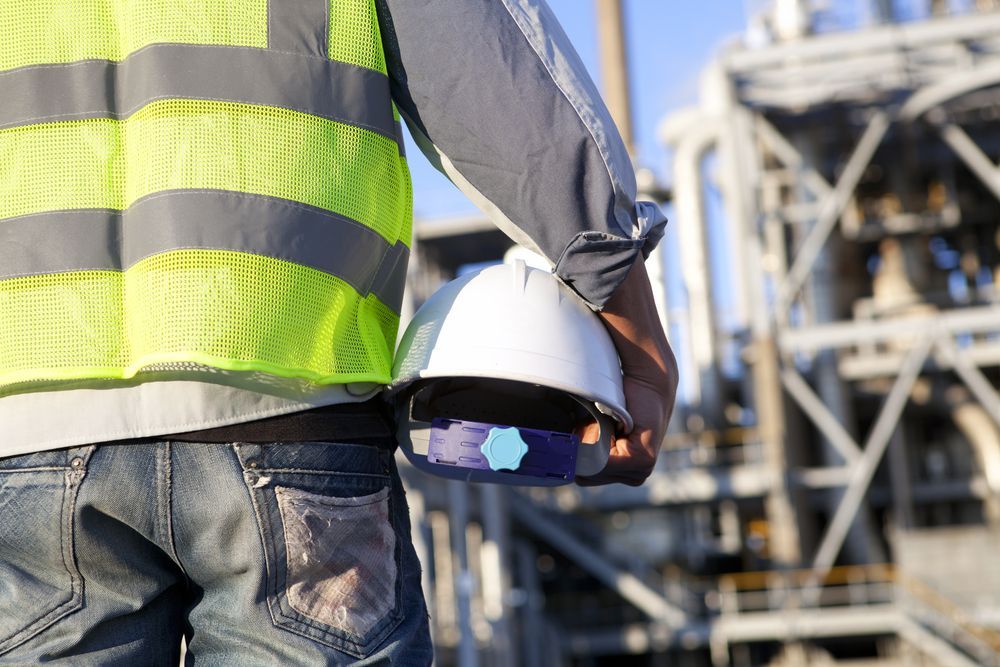 Worker Holding a Hard Hat — Construction Services in Southport, QLD