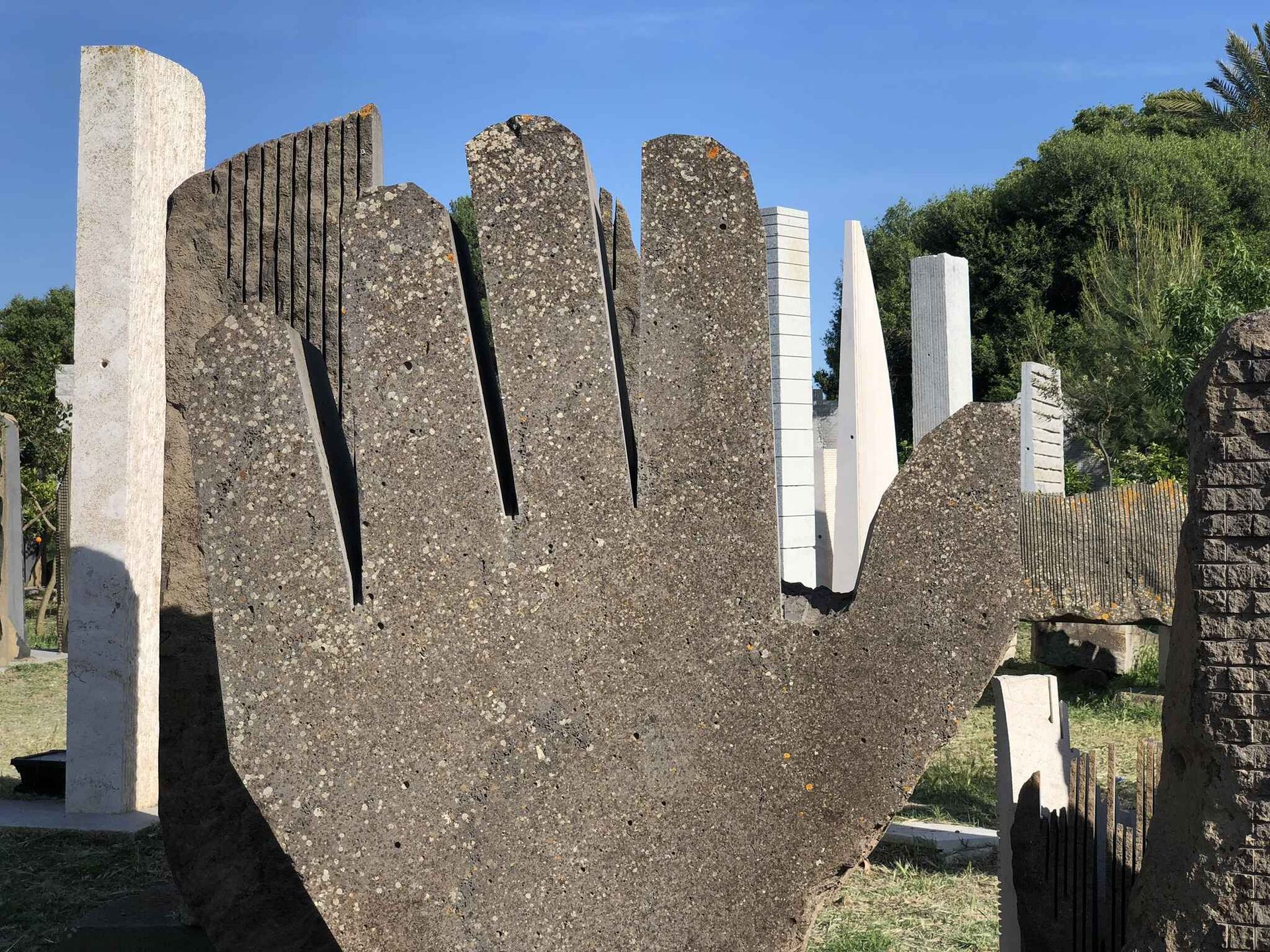 a statue of a hand is in a cemetery