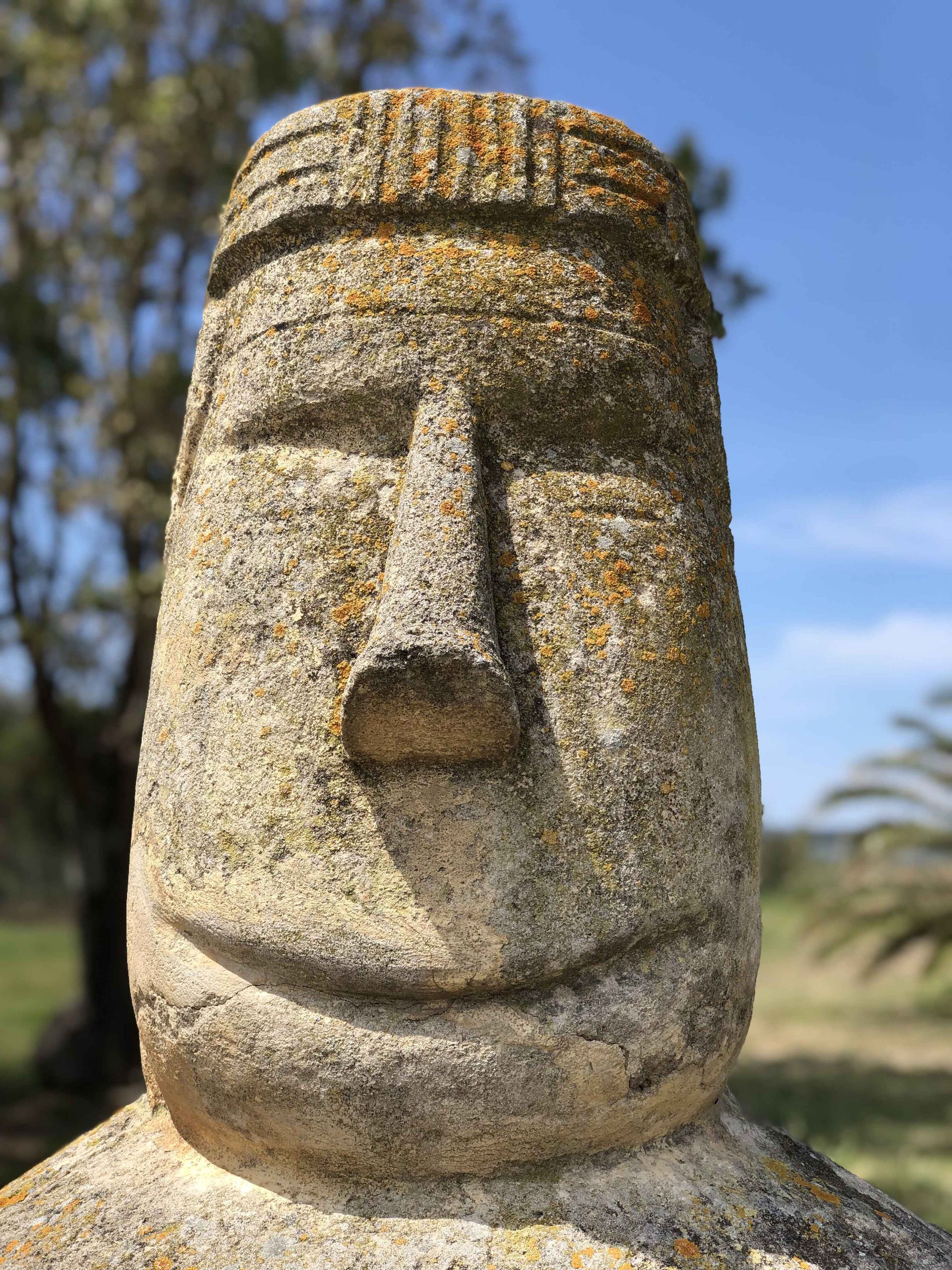 a close up of a stone statue with a smiley face