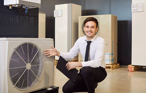 Air conditioning units with toolbox and gloves in backyard.