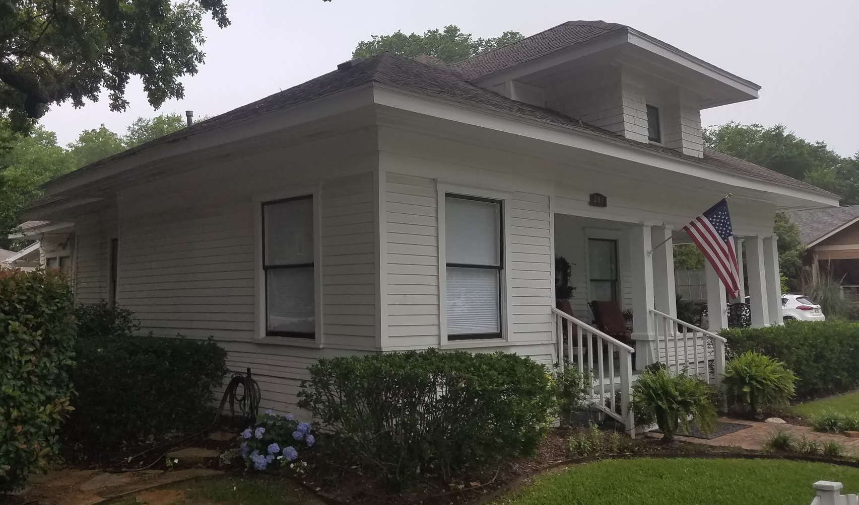 two men are working on the roof of a house
