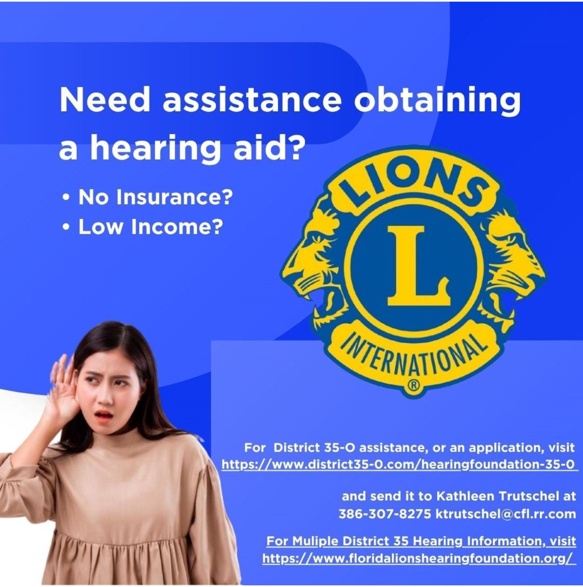 A woman is holding her hand to her ear in front of a lions international logo