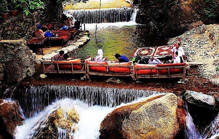 Eating food on the river,  Village of Darband in Tehran