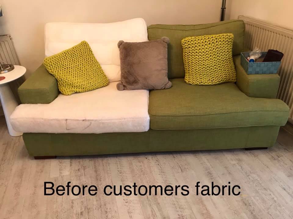Green and white sofa with cushions