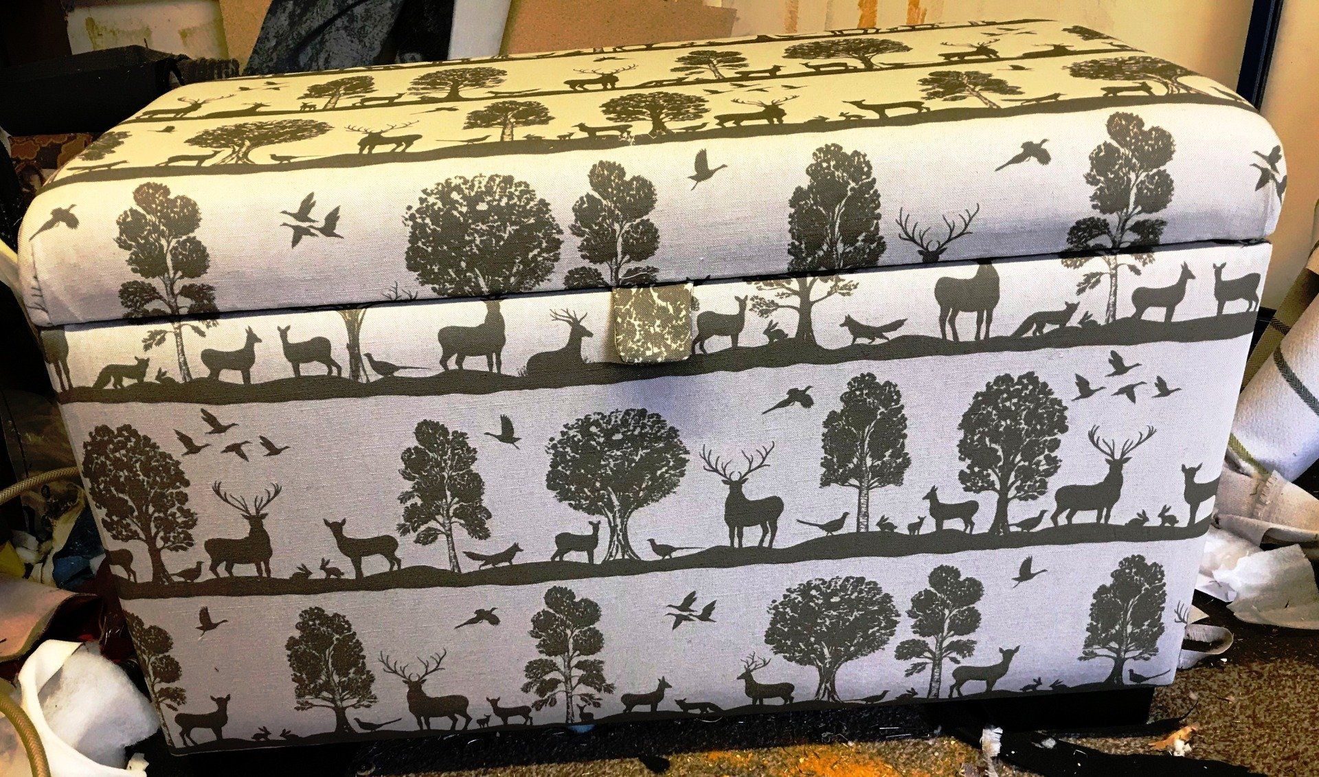 Storage box upholstered in black and white animal patterned fabric