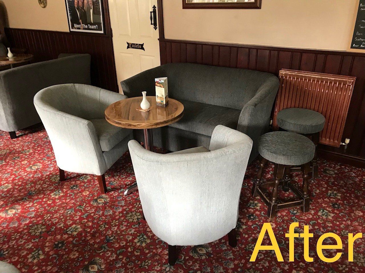 Table and seating in a pub with red carpet