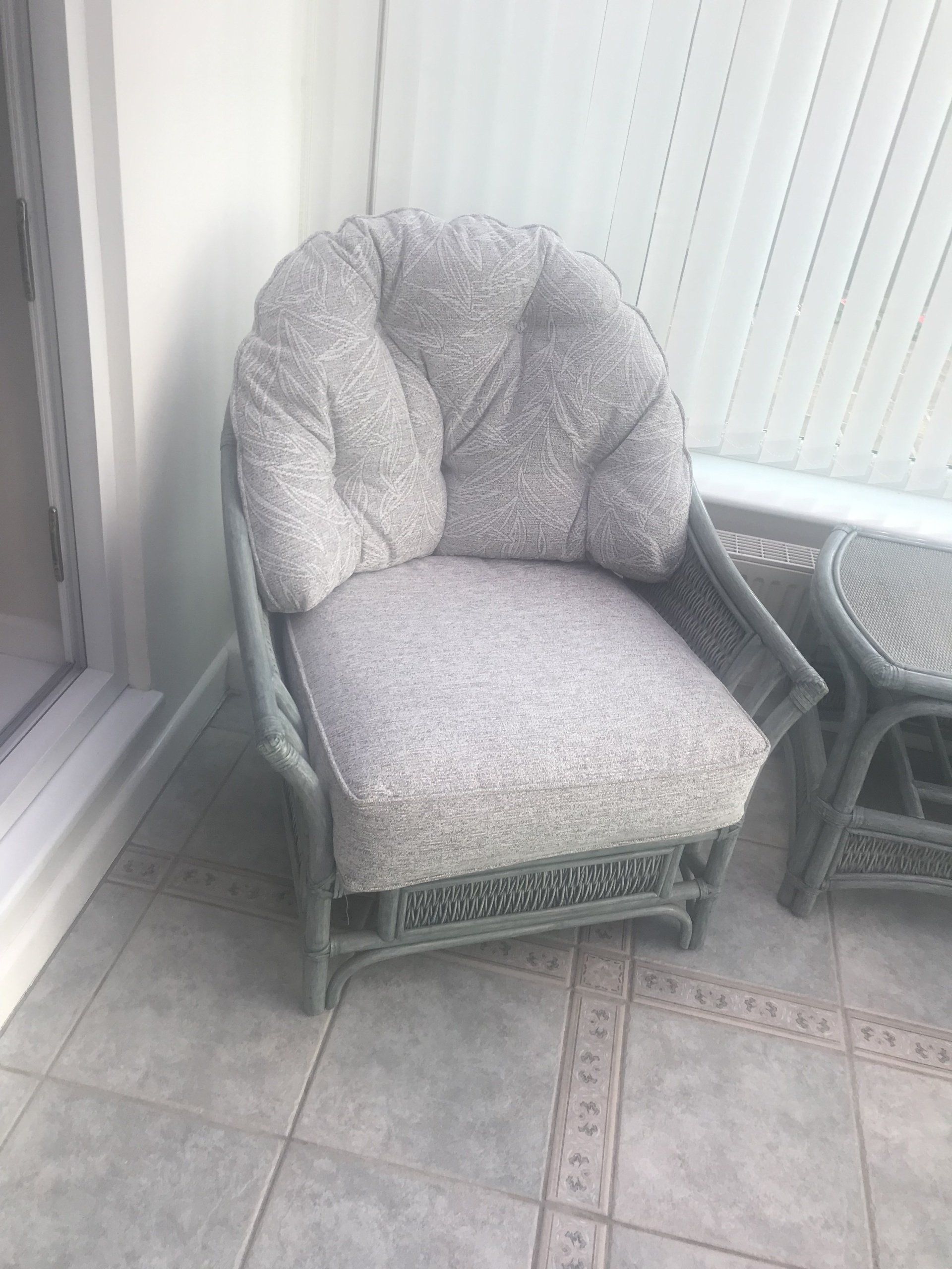 Grey wicker armchair in the corner of a room