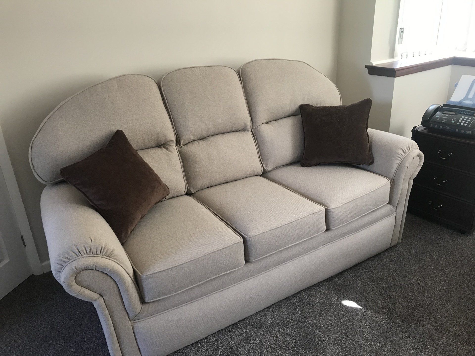 Large grey sofa with brown cushions