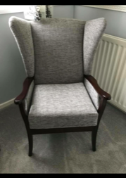 Grey chair in the corner of a rom