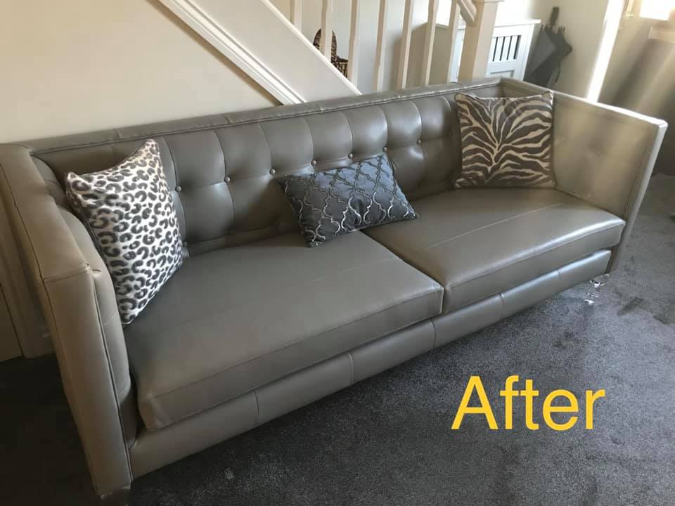 Sofa and cushions in front of a white staircase