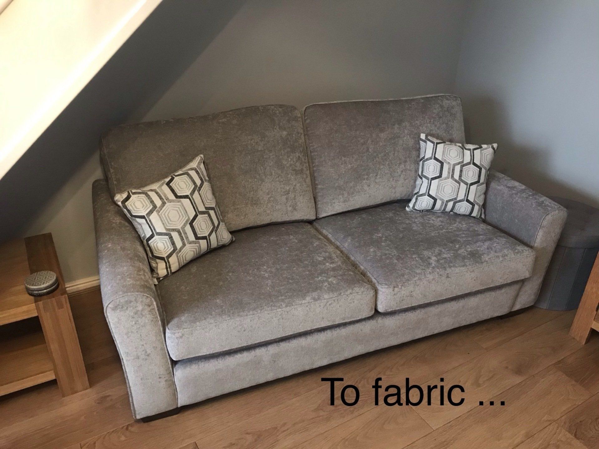 Grey sofa with geometric patterned cushions