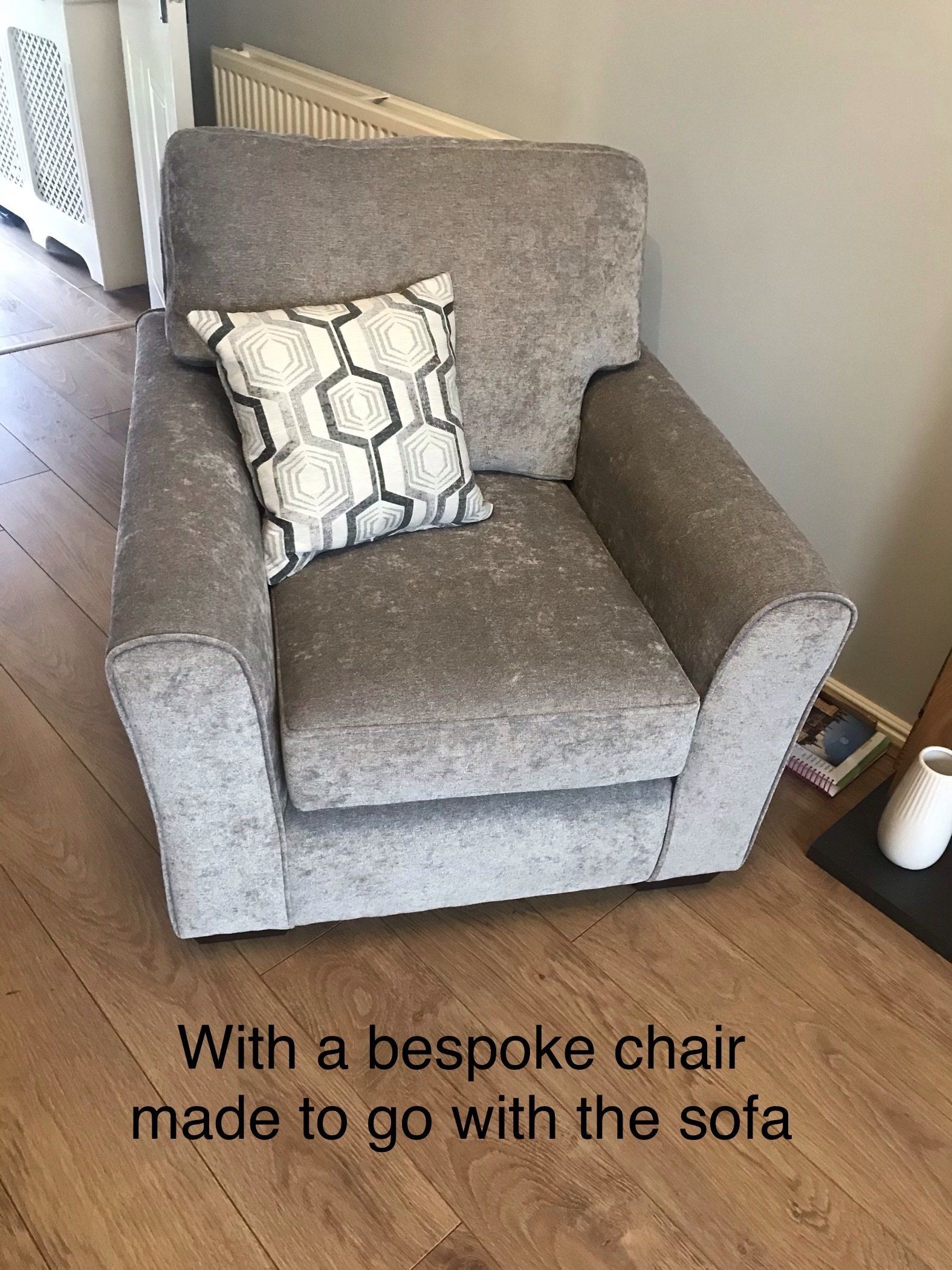 Grey armchair with geometric patterned cushion