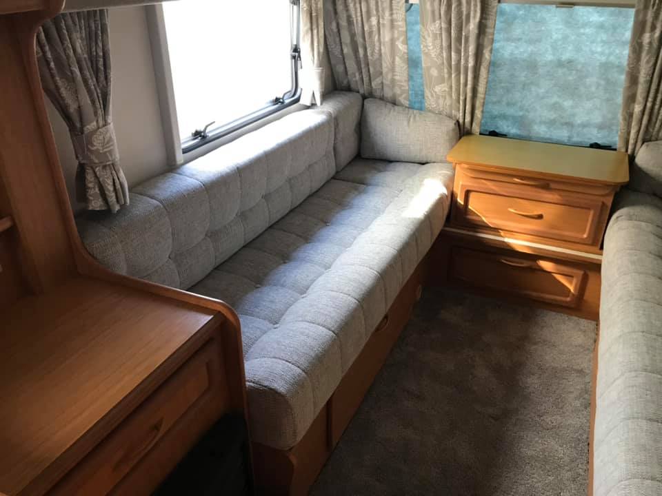 Grey sofa next to a window