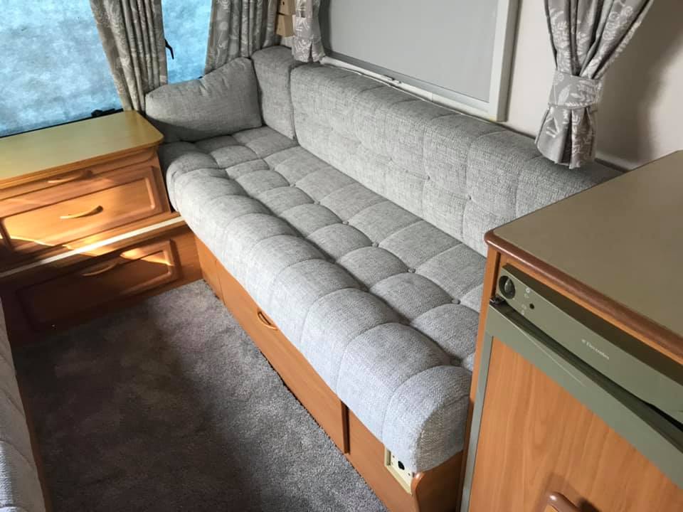 Modern grey sofa against a wall