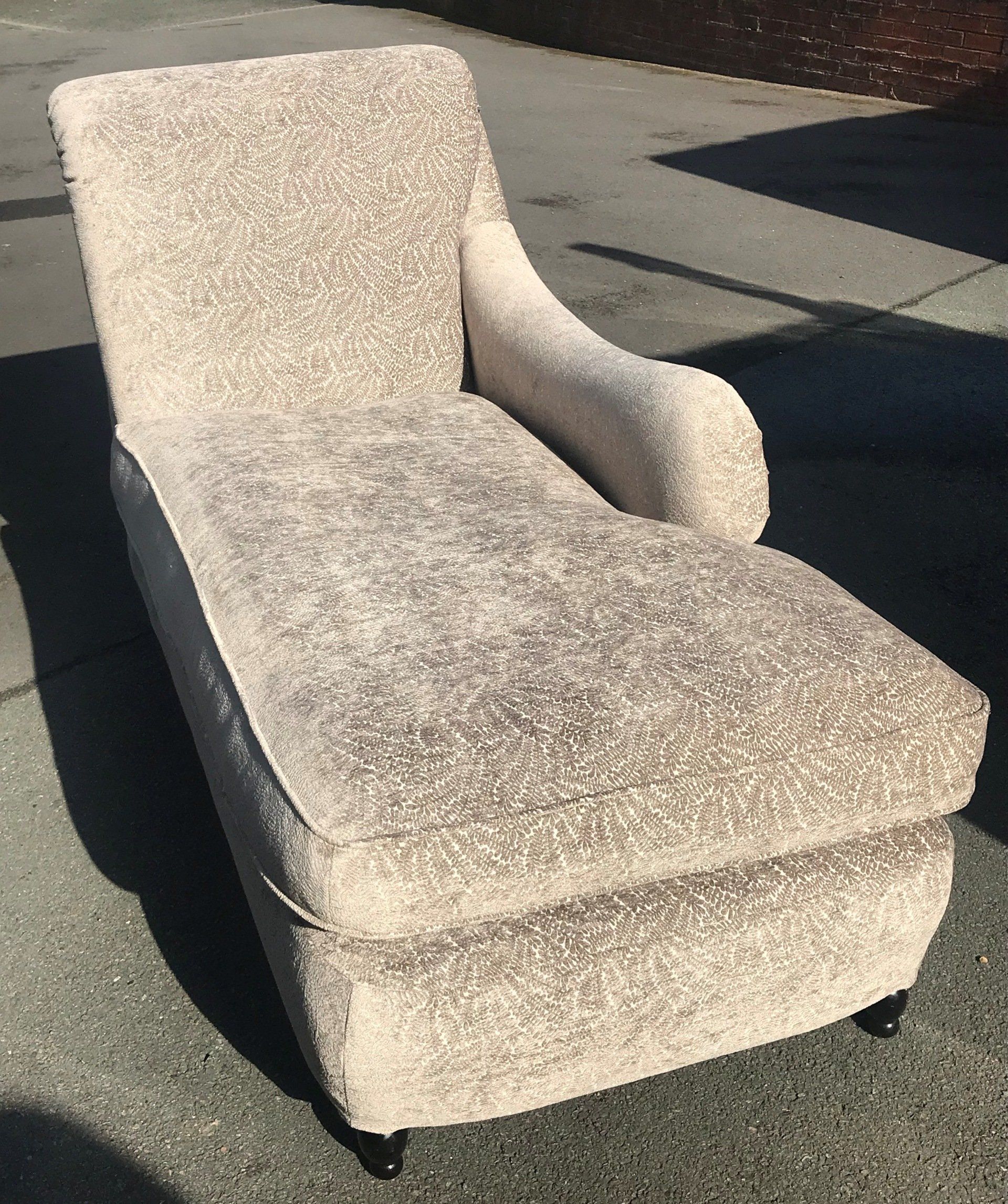 Grey chaise lounge on the pavement
