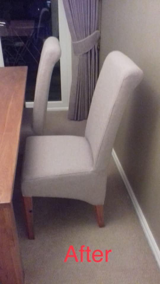 Grey dining chairs at a wooden table in a grey room
