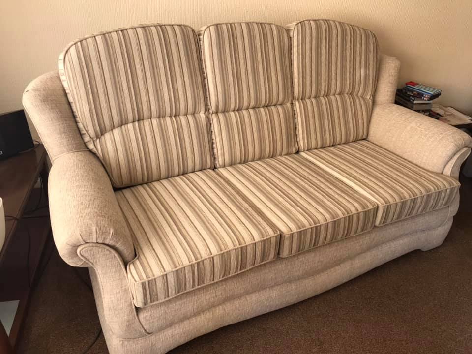 A cream coloured striped sofa