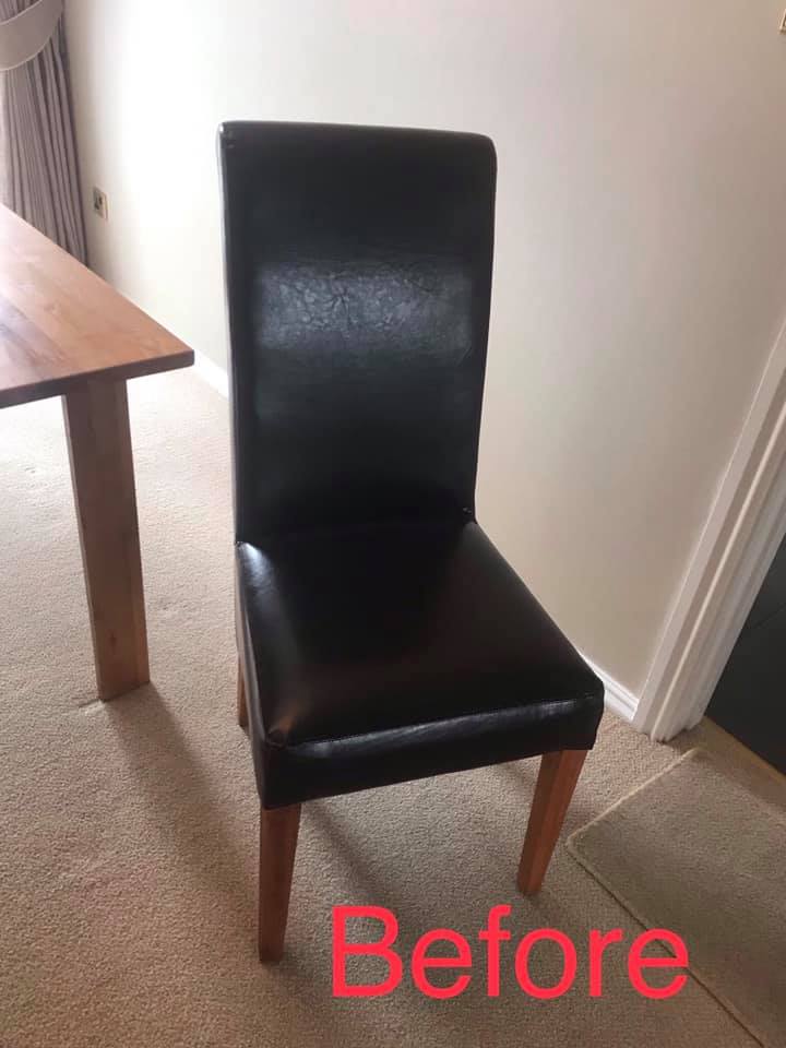 Black leather dining room chair with table in the background