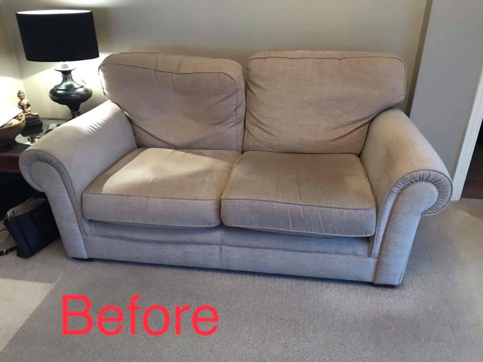 Tired and misshapen grey sofa