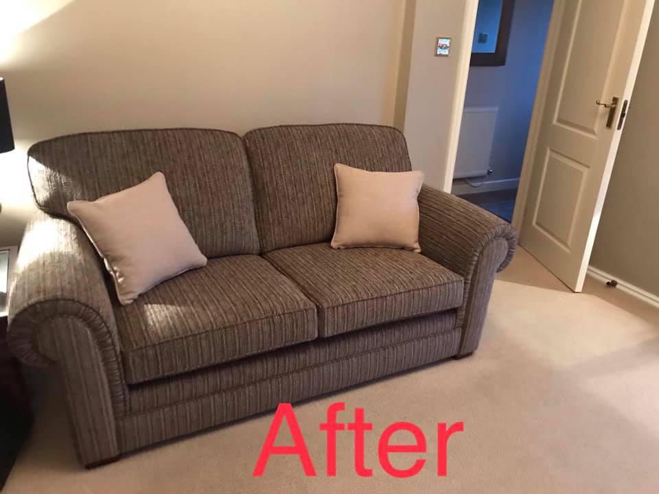 Dark grey sofa with white cushions