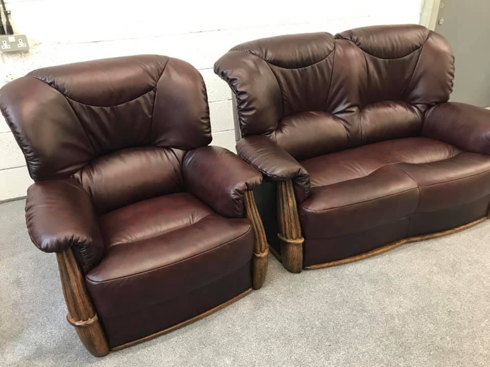 Two matching brown leather armchairs