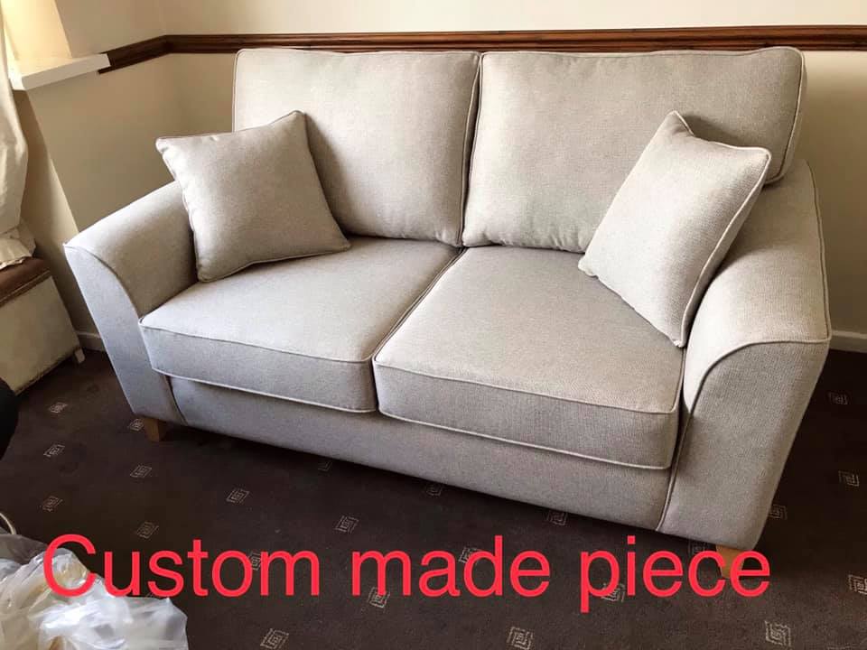 A large light grey sofa with matching cushions