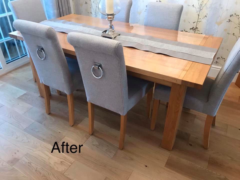Dining room table with grey chairs and a matching table runner
