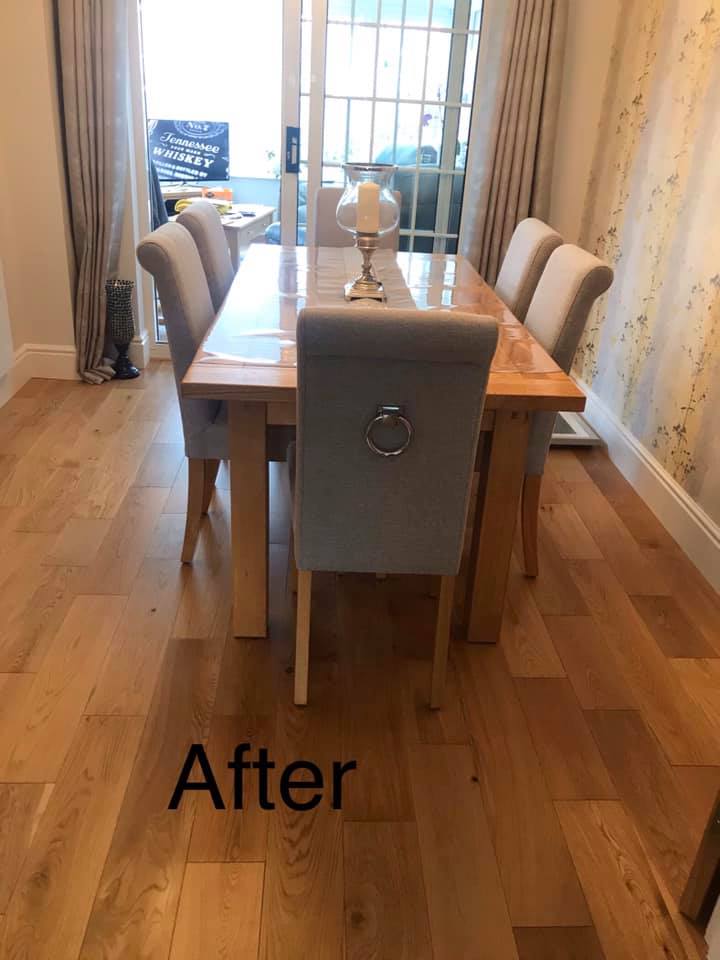 A bright dining room with a rectangular table and chairs around it