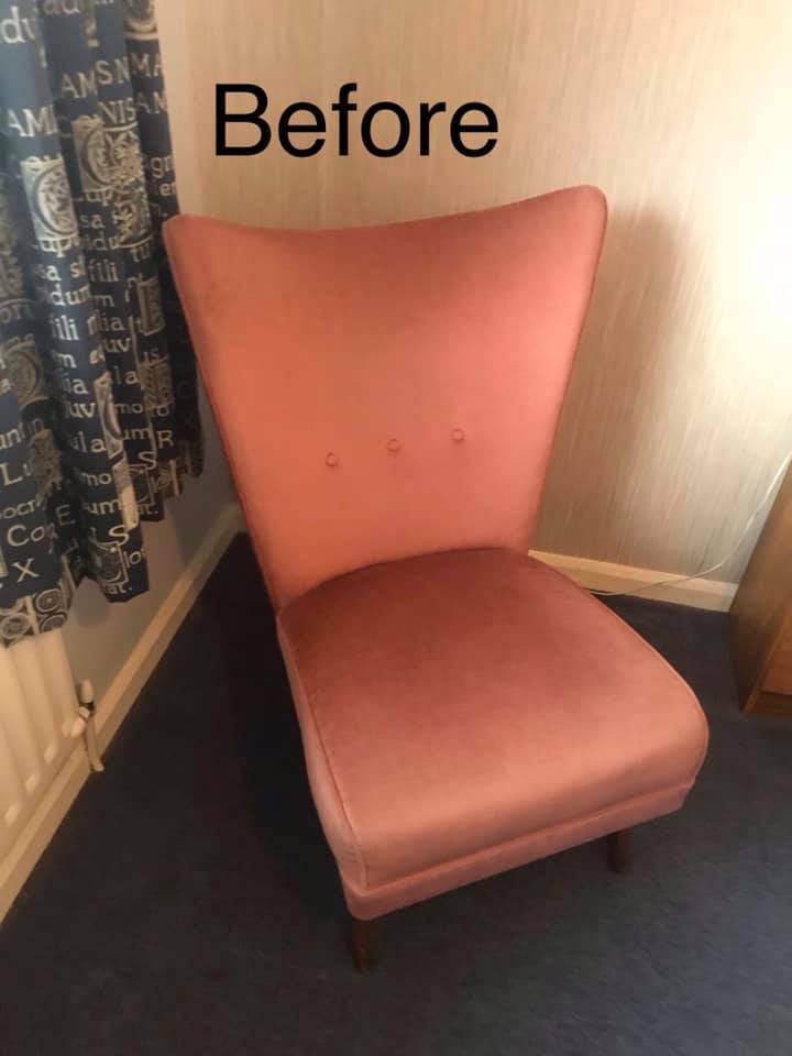A pale pink dining room chair on a blue carpet
