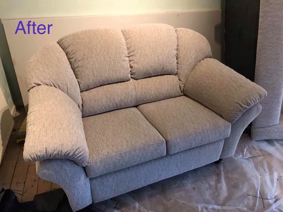 A small and deep cream coloured sofa