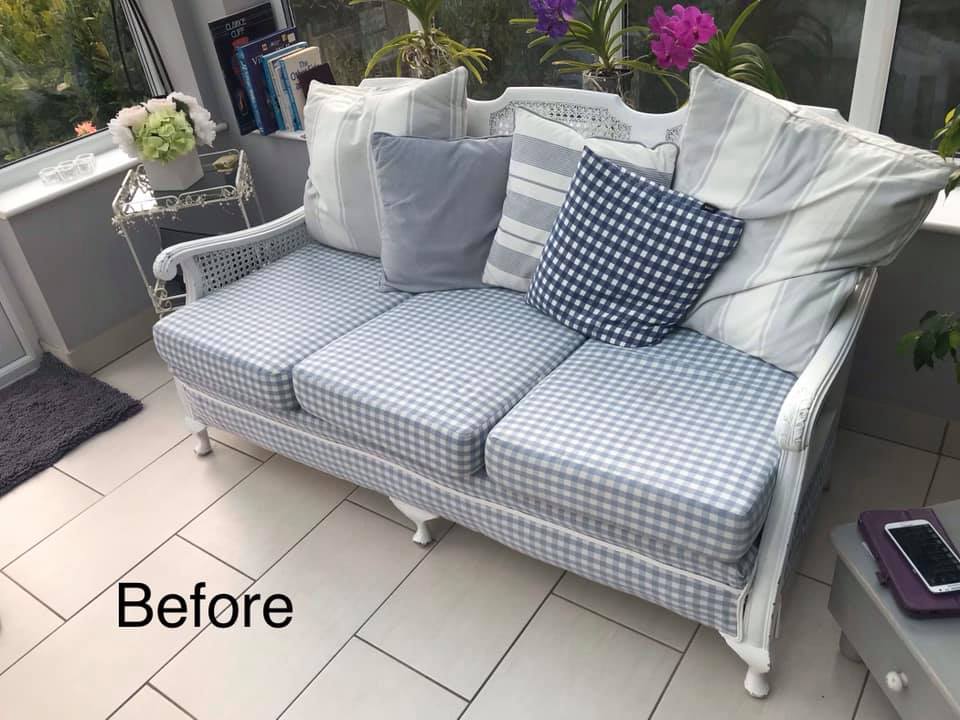 Large sofa with grey check upholstery and lots of cushions
