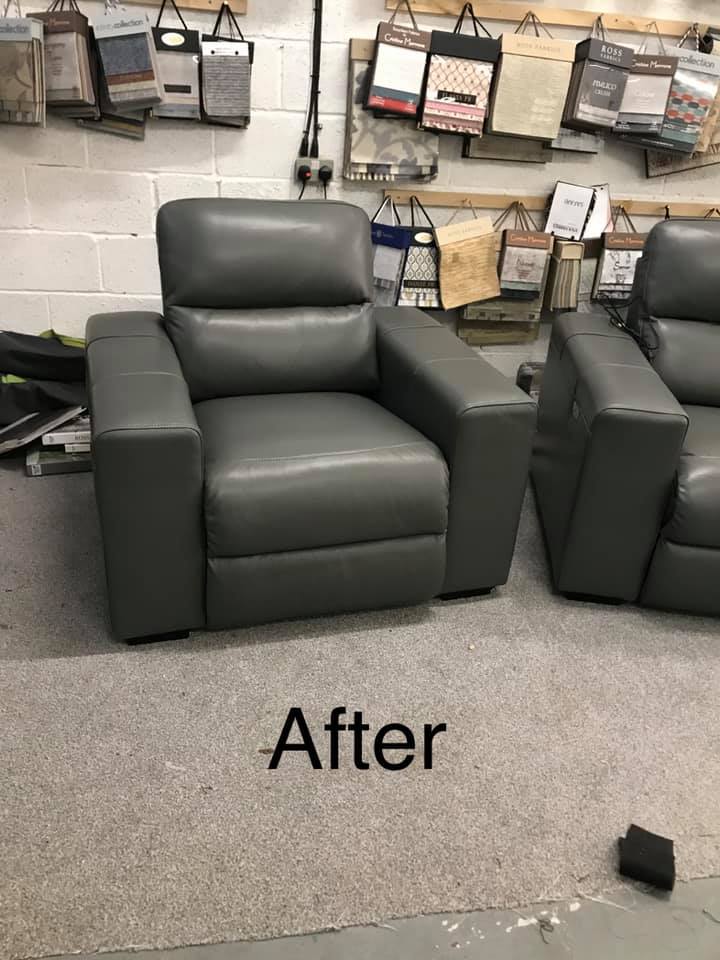 A pair of black leather armchairs