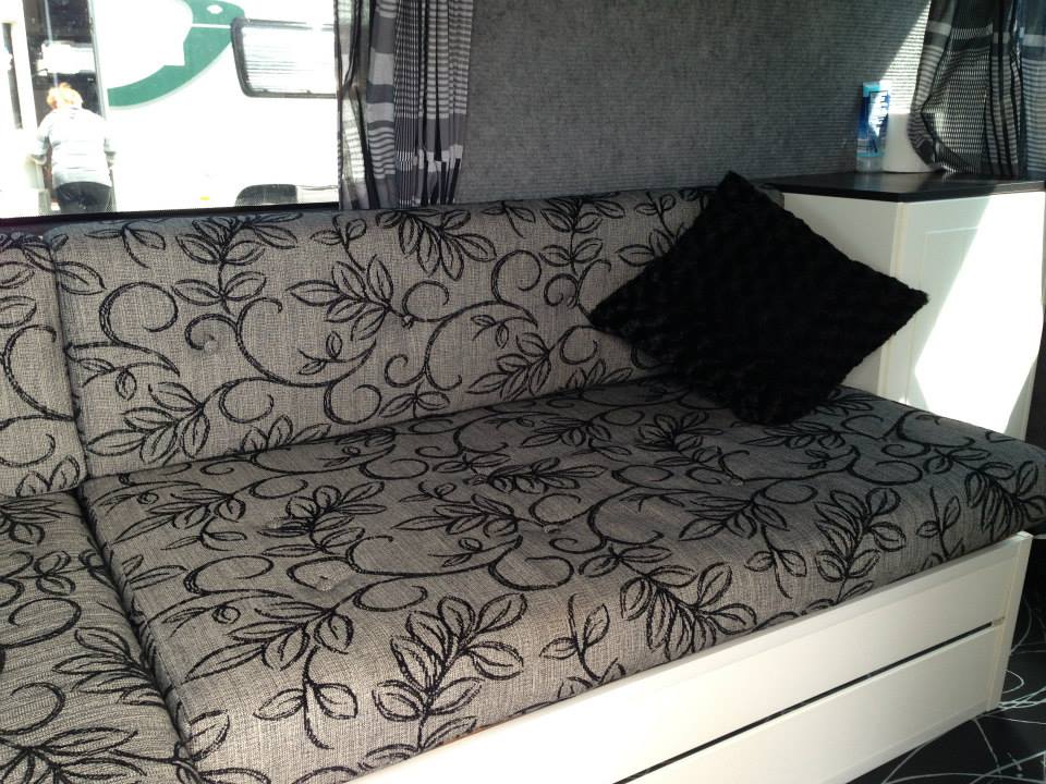 Black floral sofa with black cushions