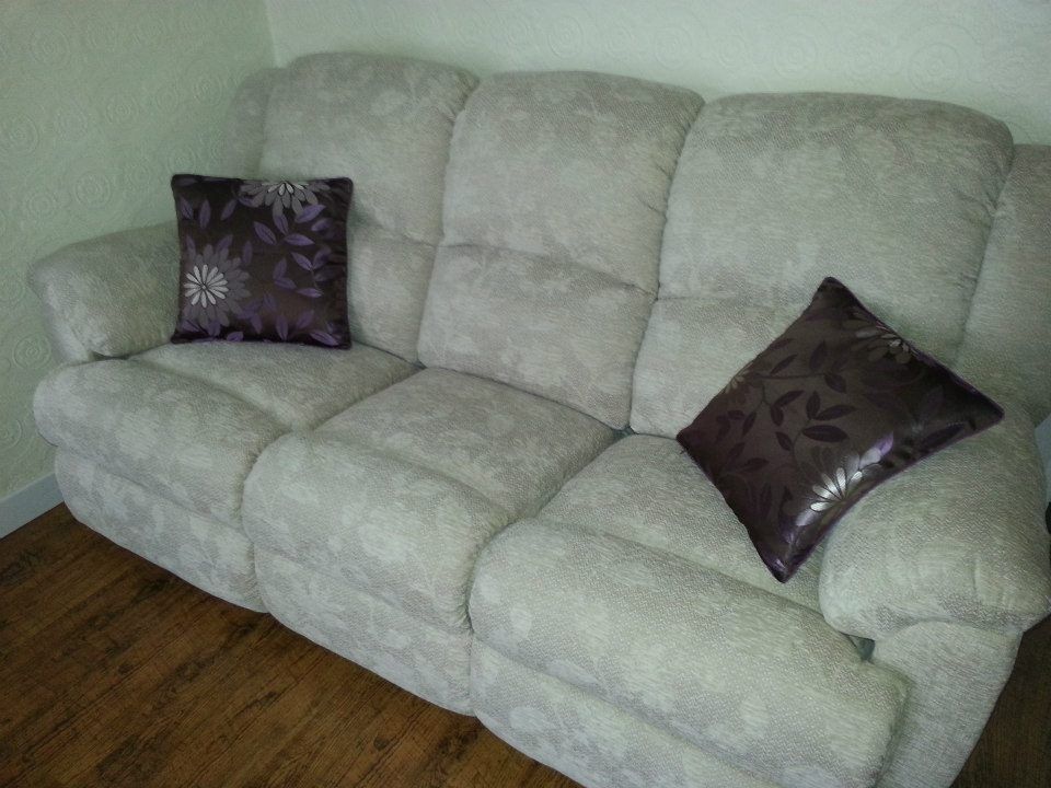 Light coloured large sofa with dark cushions