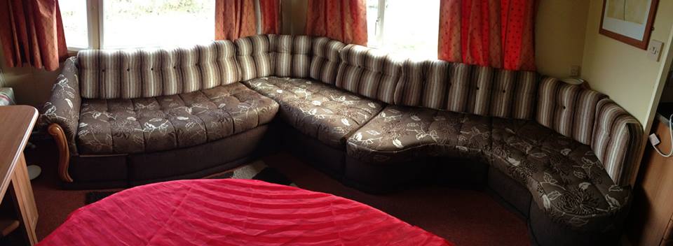 Brown corner group in a room with red curtains