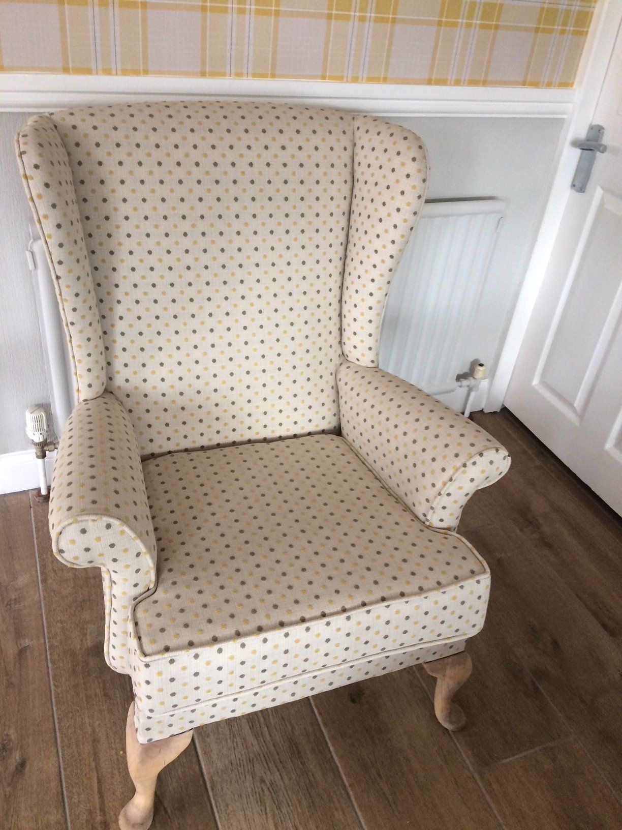 Light coloured armchair on a wooden floor