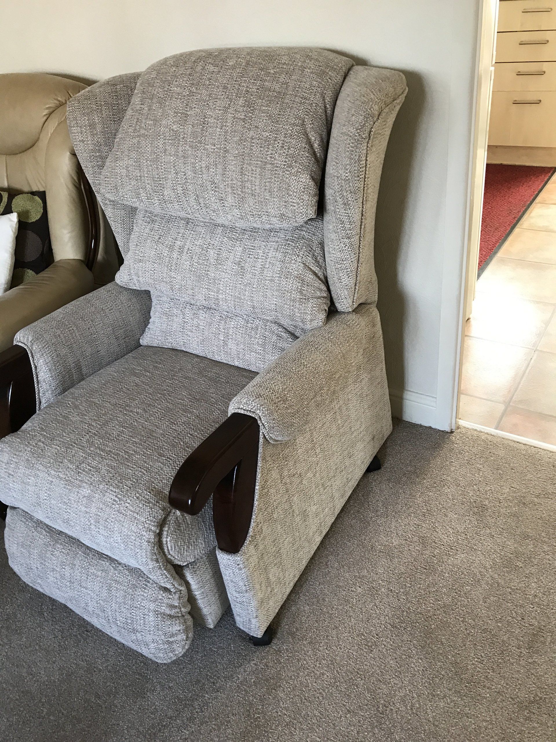 Large grey armchair next to a doorway
