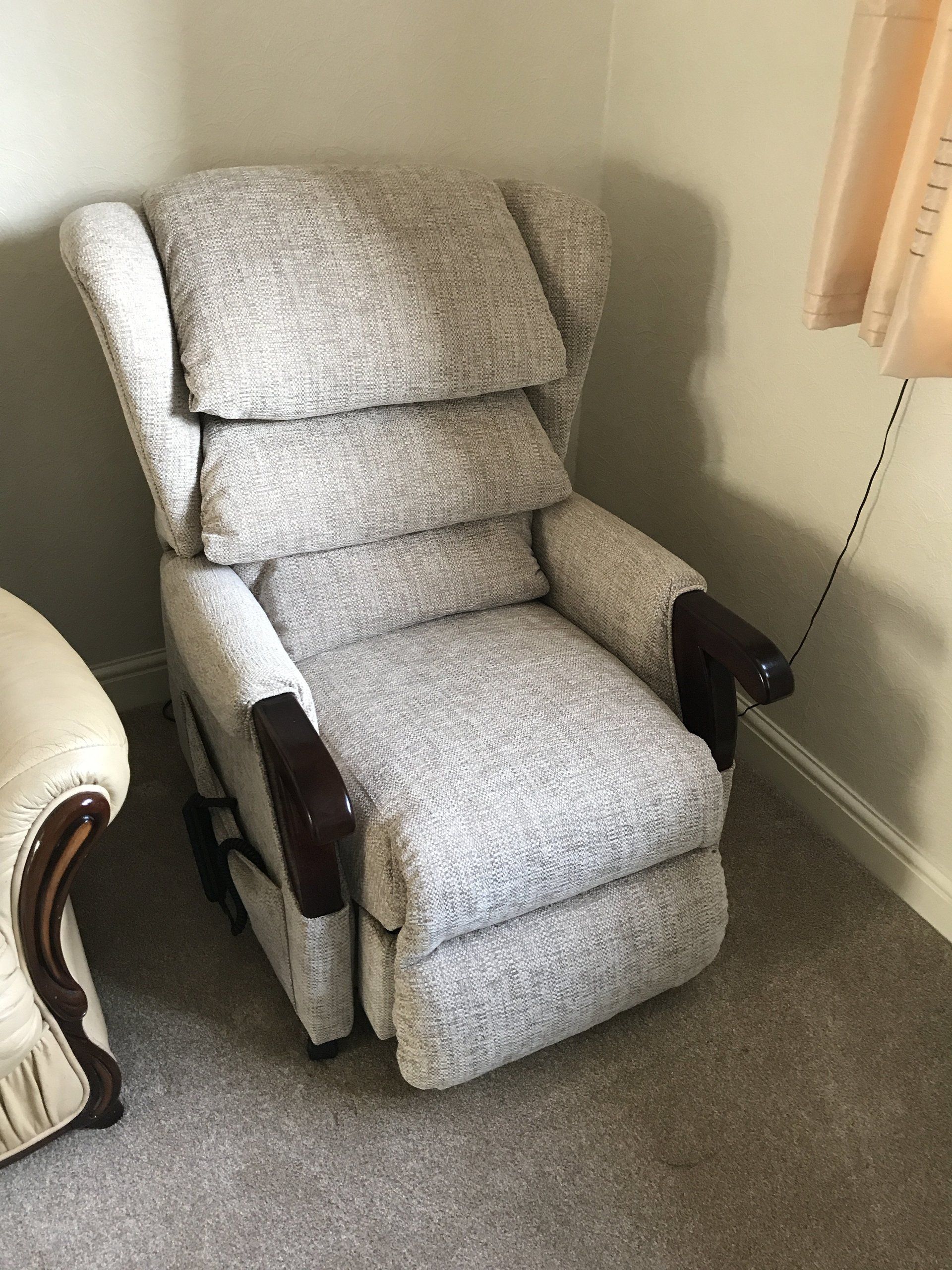 Large grey armchair in the corner of a room