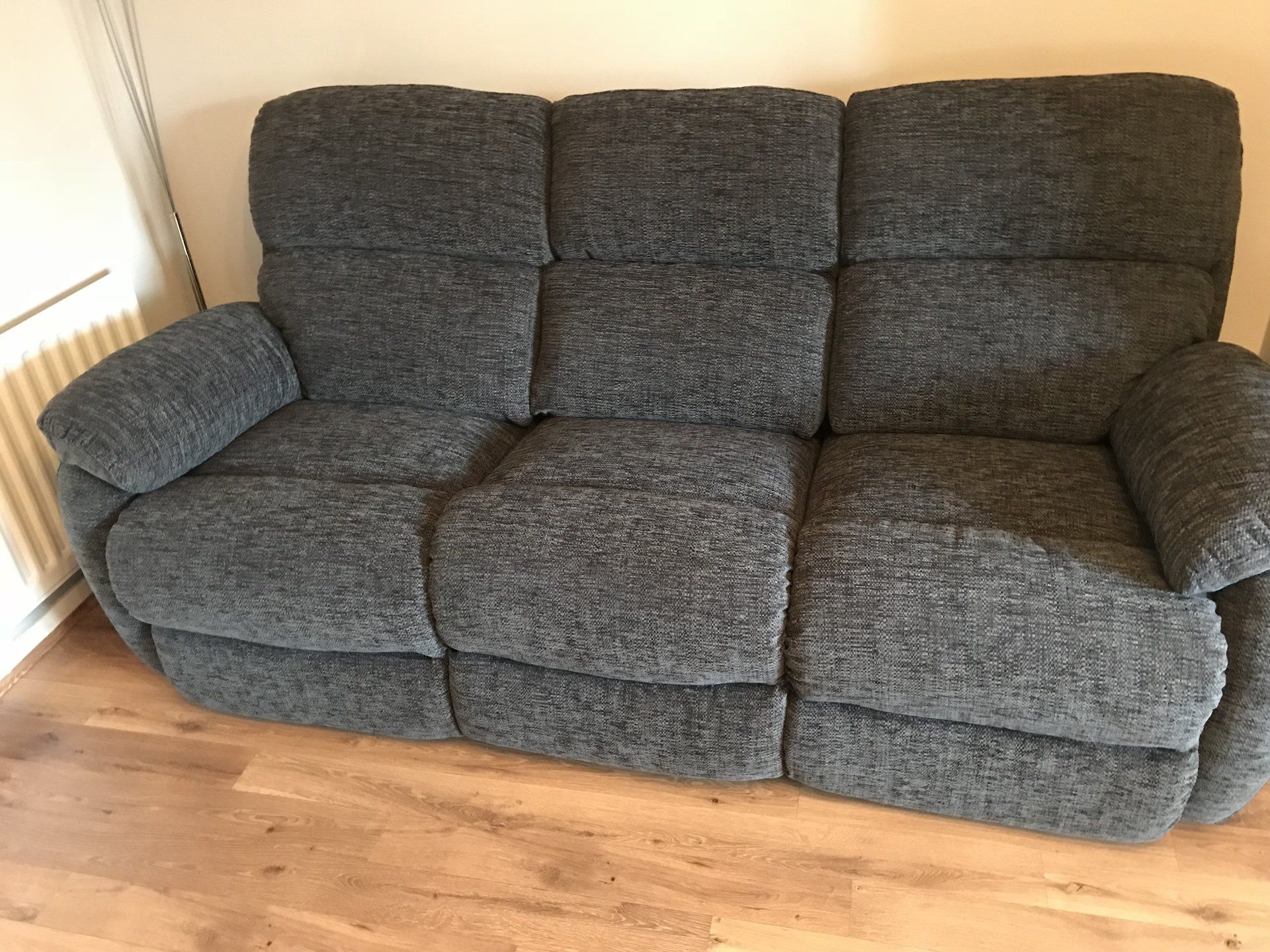 Dark grey sofa on wooden floor