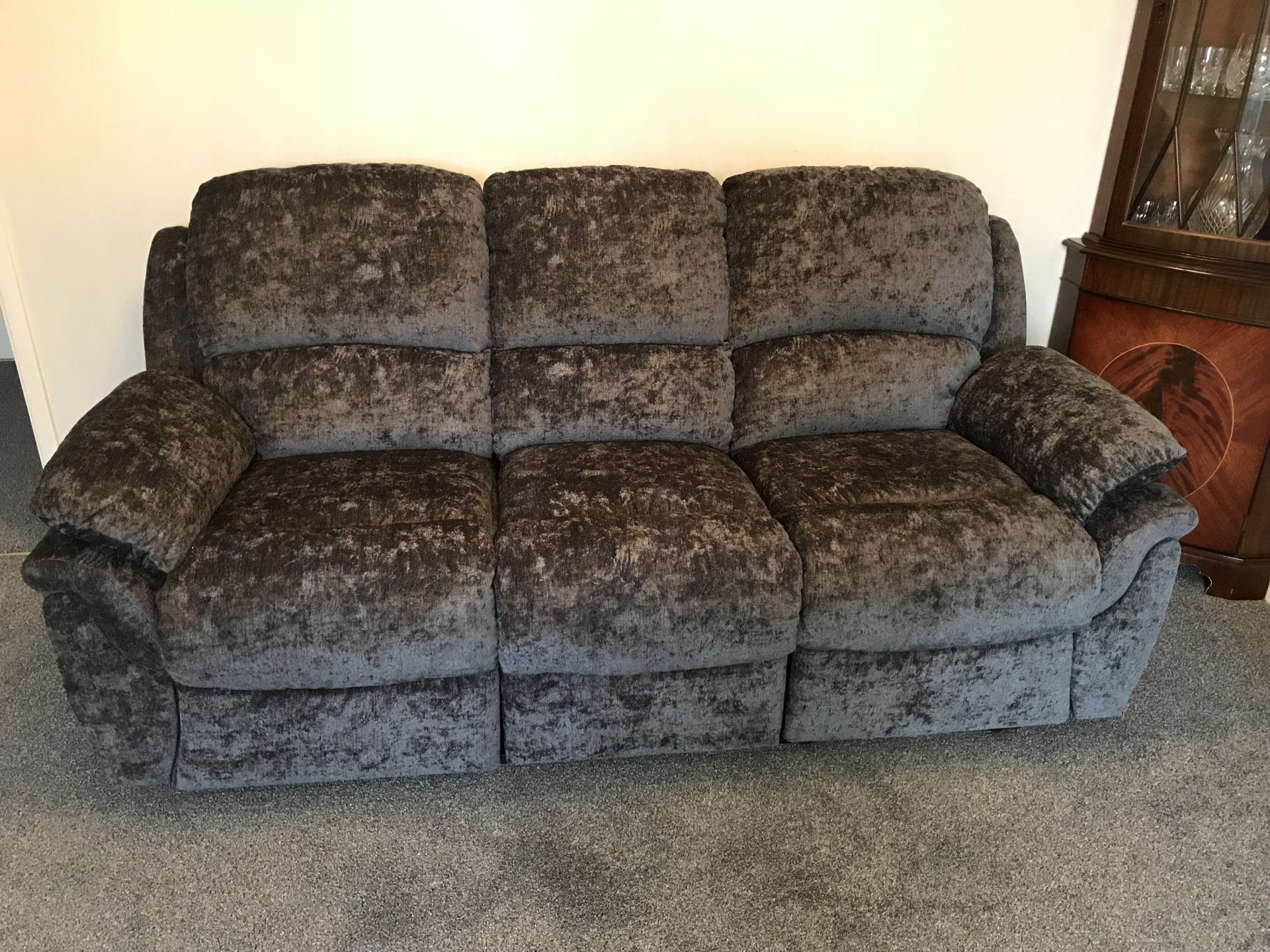 Dark coloured velvet sofa in a room