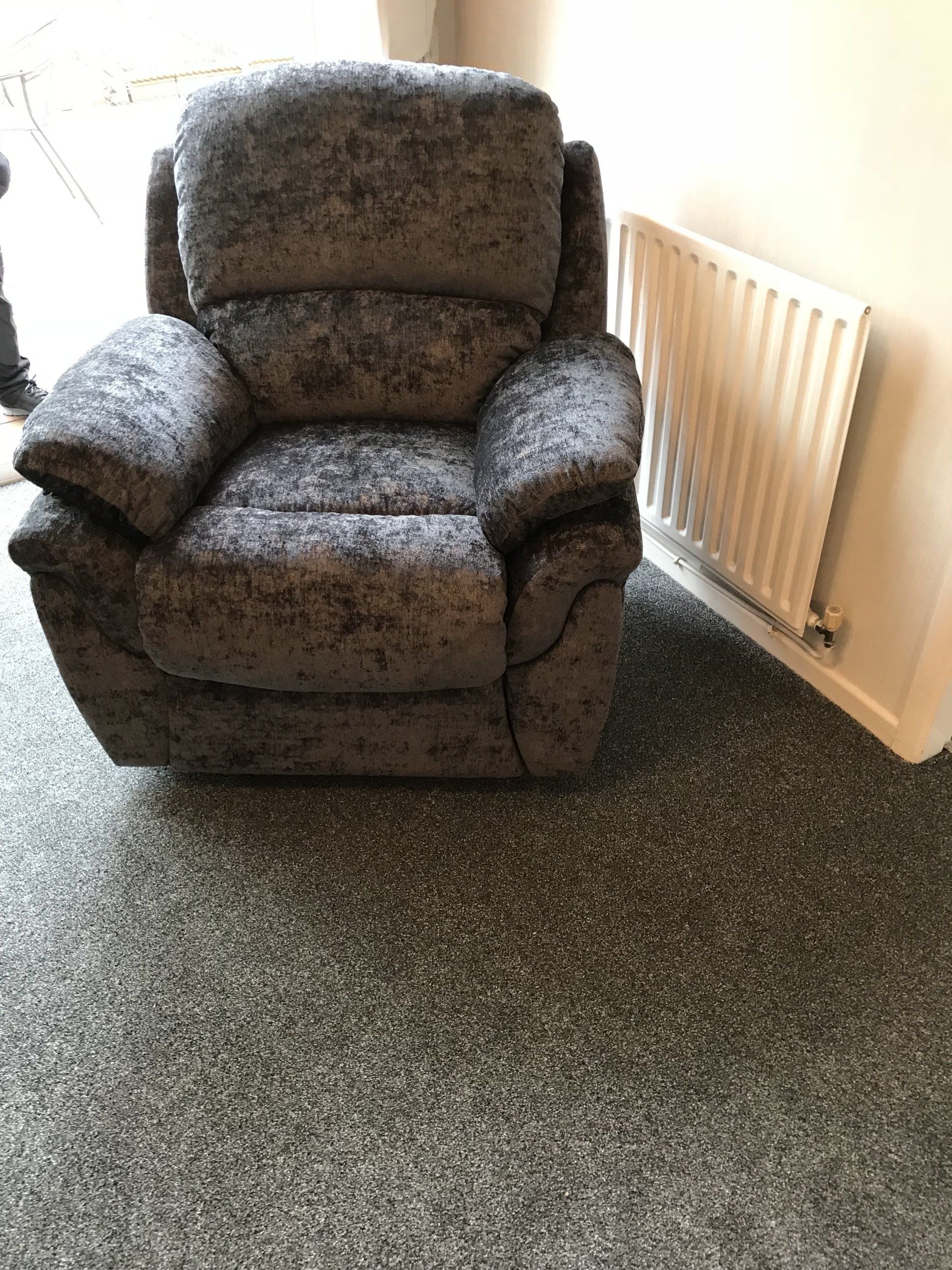 Dark coloured velvet armchair