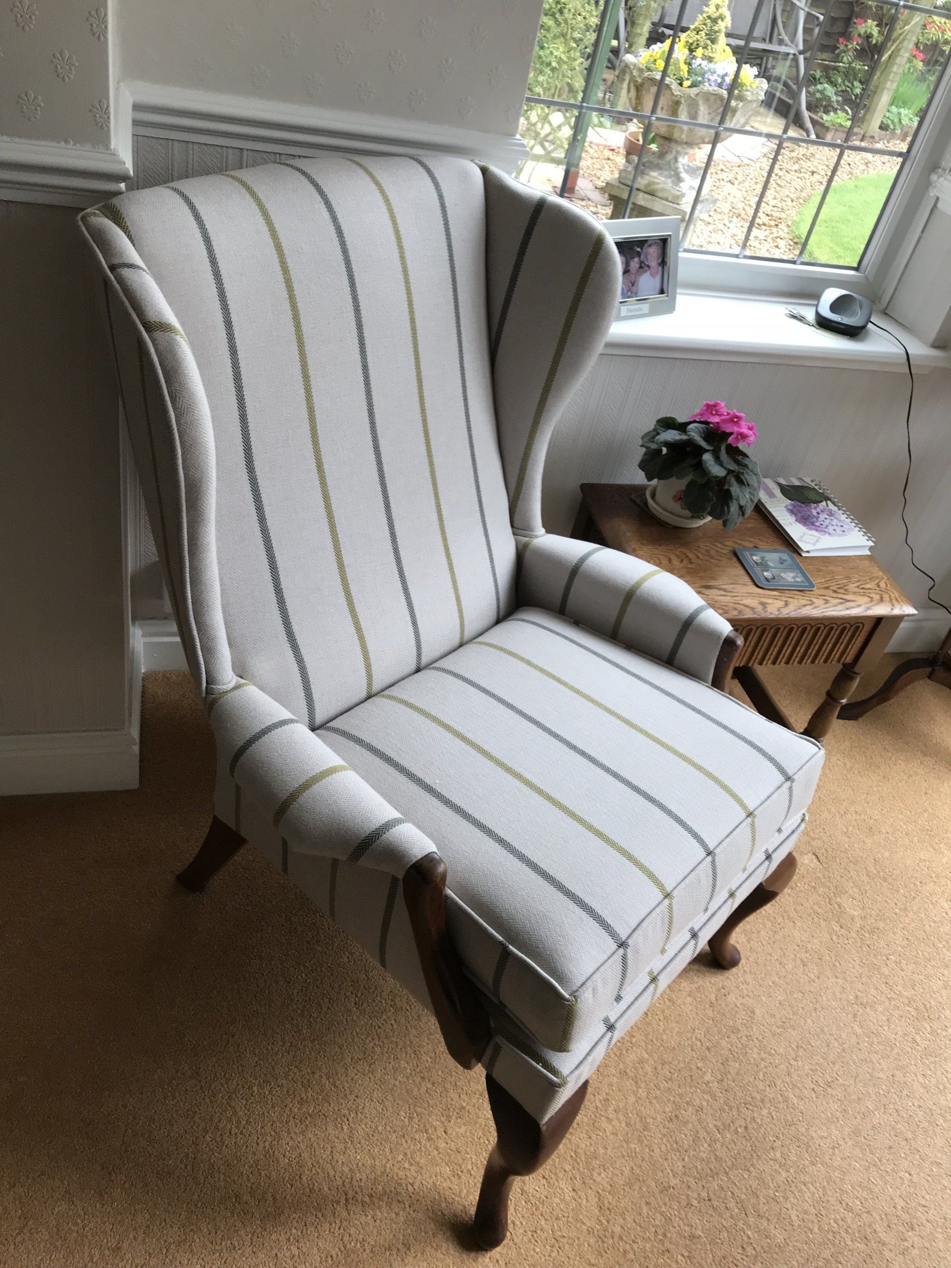 Side angle of a light coloured striped armchair