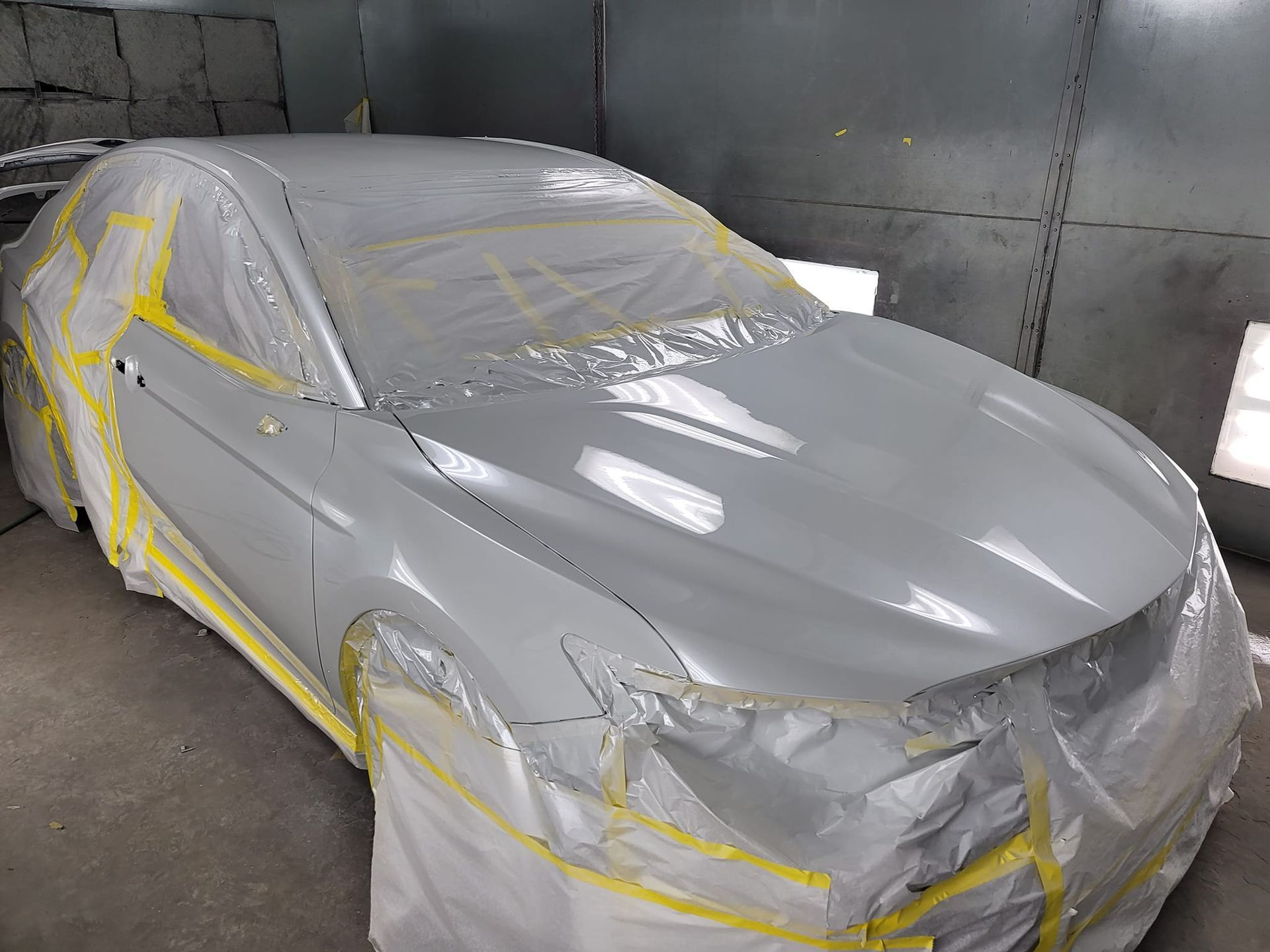 Car sitting and drying after being painted.